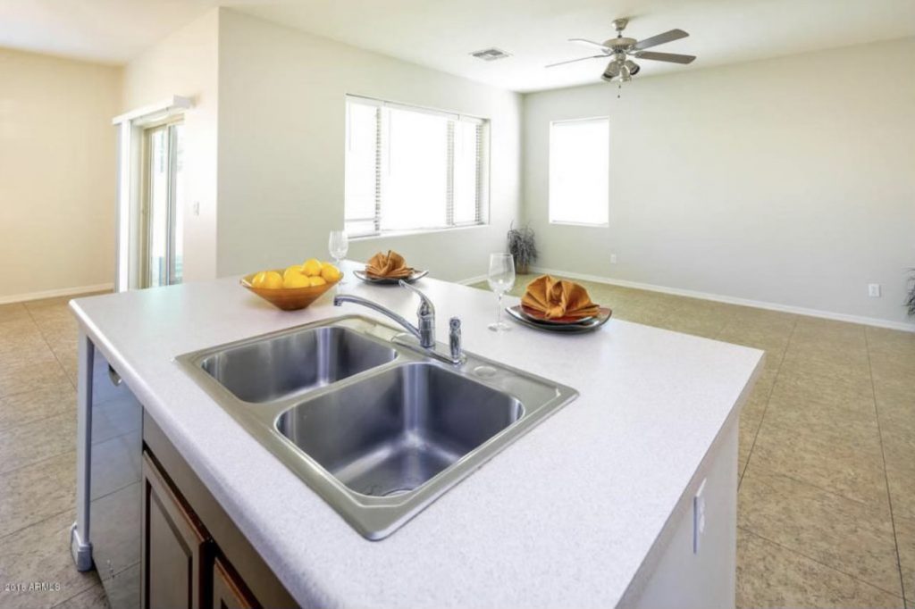 view from the kitchen displaying the island and living room beyond it