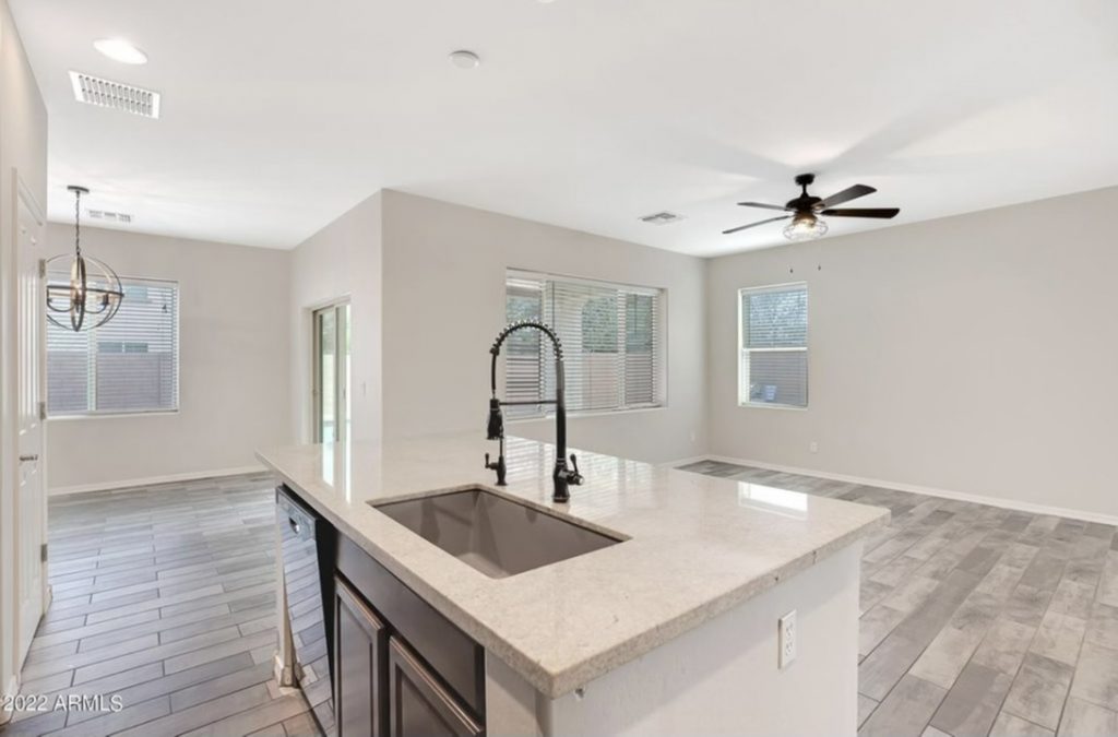 after view of the island featuring a modern sink and faucet